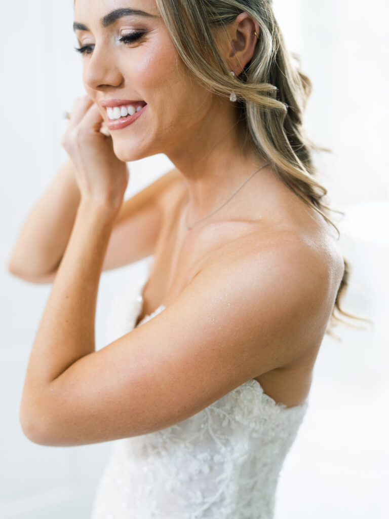 Close portrait of bride smiling while getting ready for her elegant fall wedding at The Bryan Museum.