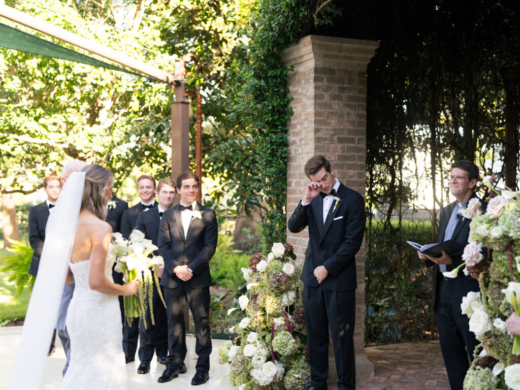 emotional moment for the groom as the bride walks down the aisle at a romantic fall wedding at The Bryan Museum.