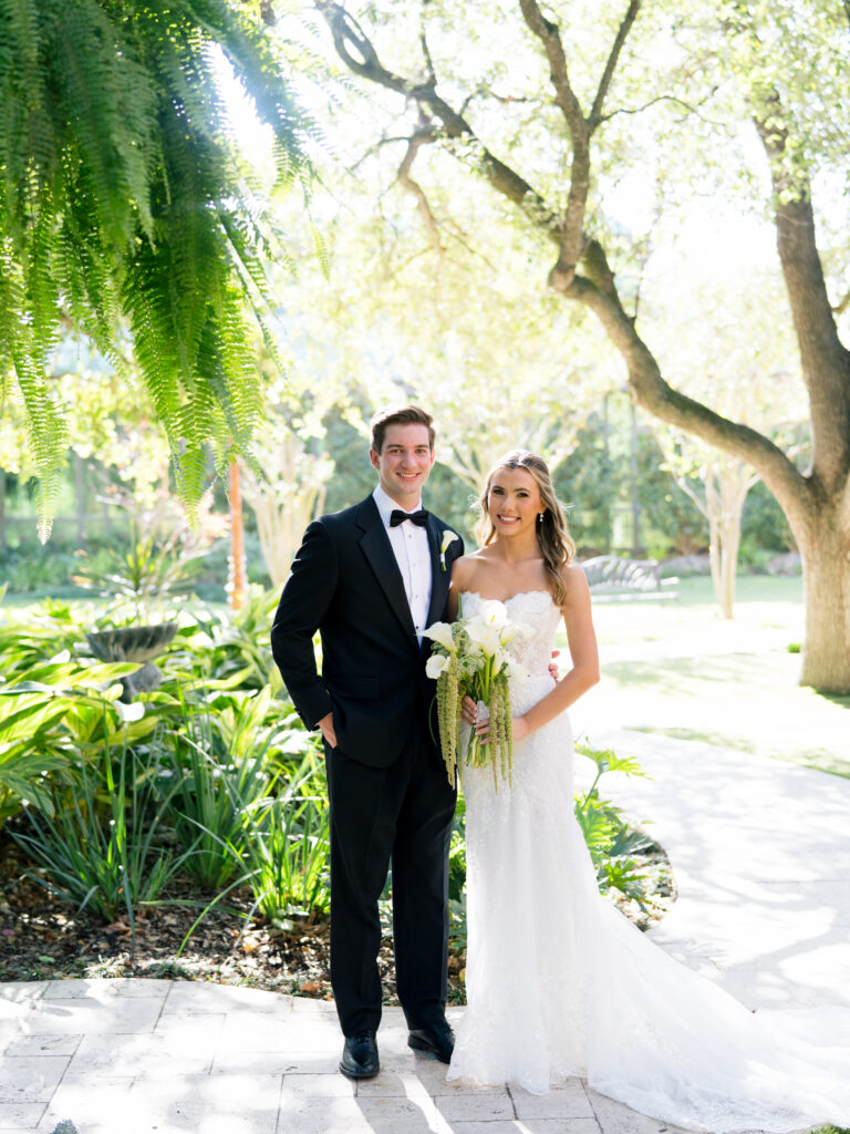 Bride and groom portraits beneath the trees during romantic fall wedding at The Bryan Museum.