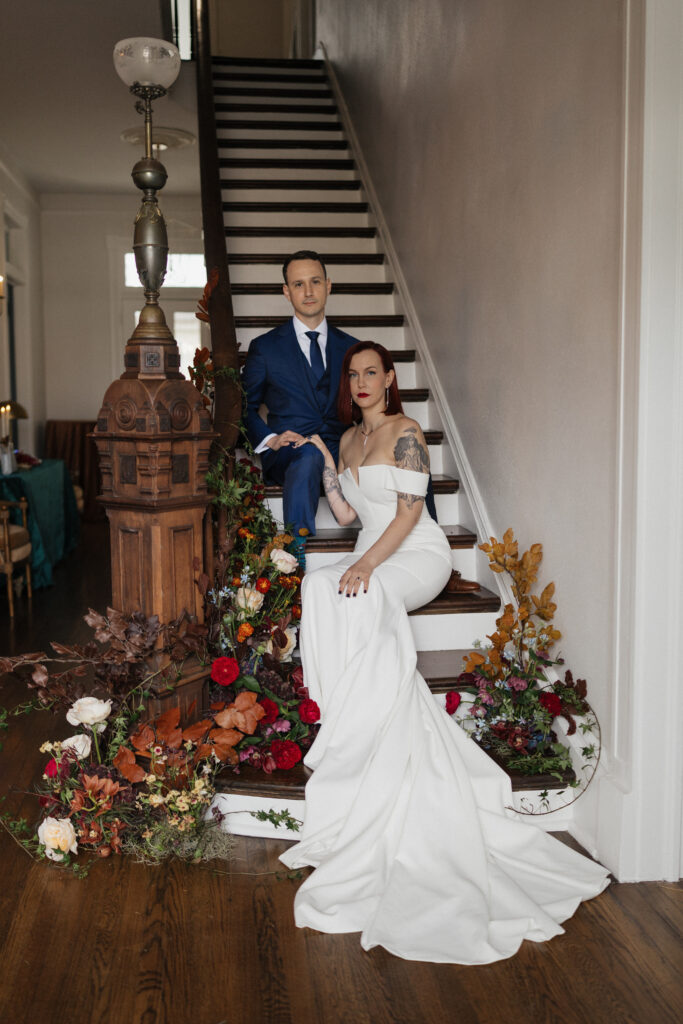 Bride and groom by the stairs during their Carr Mansion wedding in Galveston, Texas.