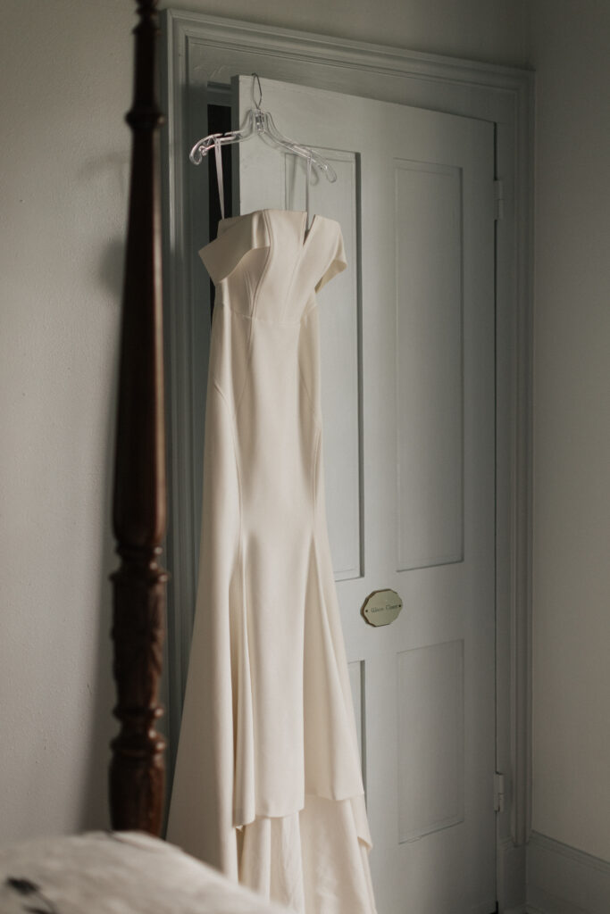 Bridal gown hanging inside Carr Mansion before a wedding ceremony in Galveston, Texas.