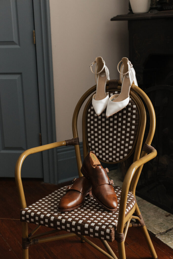 Groom's and bride's wedding shoes and accessories styled for a Carr Mansion wedding day.