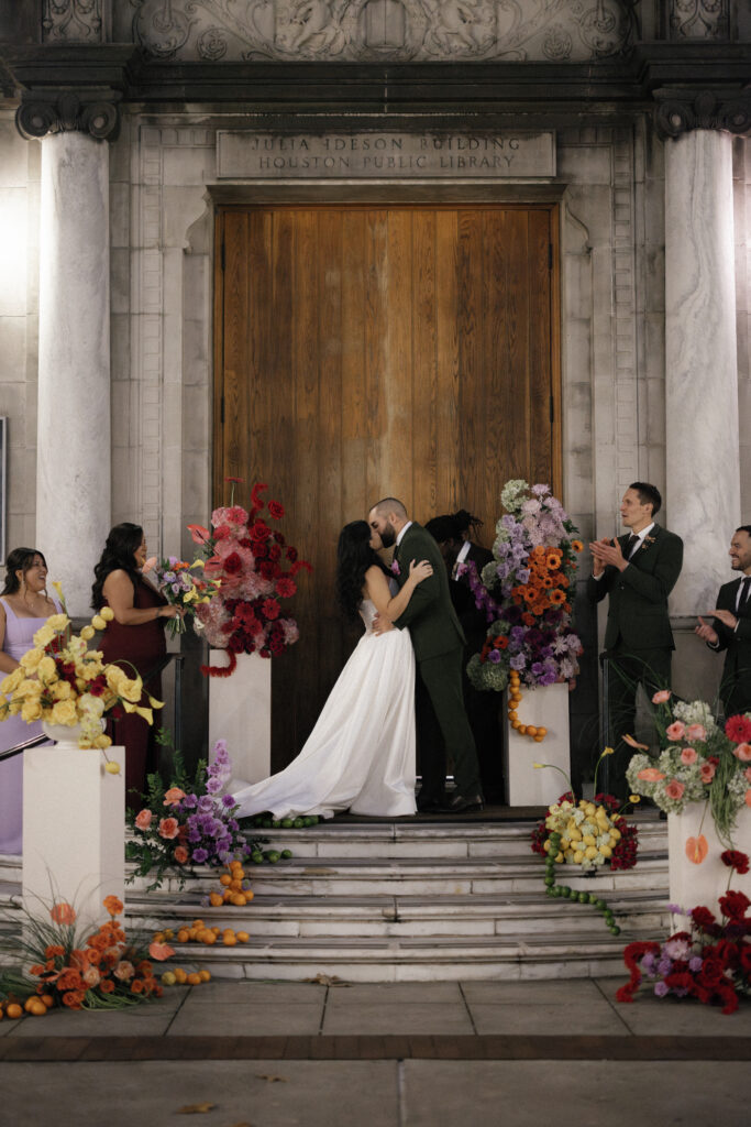 Jessica and Michael shares first kiss as a newlywed couple during their Julia Ideson Library ceremony.
