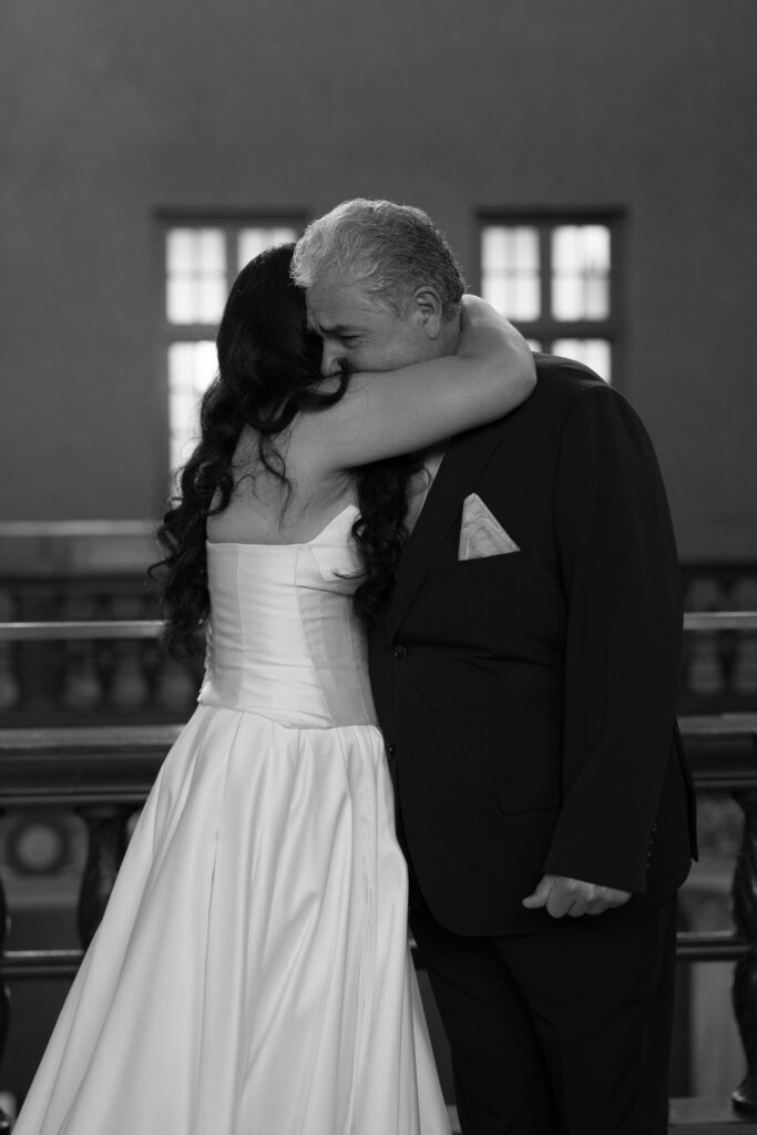 Jessica hugging her father during their emotional first look at the Julia Ideson Library.